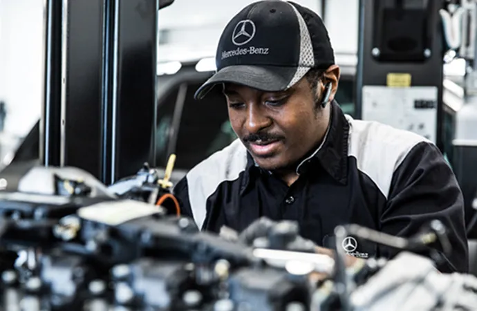 A service technician works diligently on repairs.